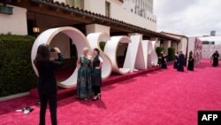 Celebrities and guests walk the red carpet at the Oscars in Los Angeles, California, April 25, 2021.