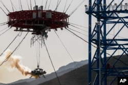 A lander is lifted during a test of hovering, obstacle avoidance and deceleration capabilities at a facility in Huailai in China's Hebei province, Nov. 14, 2019.