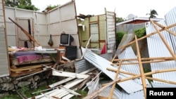 Debris lies in front of a house which lost its roof and walls after strong winds of Hurricane Elsa passed St. Michael, Barbados, July 2, 2021. 