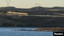 FILE - Dakota Access Pipeline equipment is seen near Lake Oahe, near the Standing Rock Indian Reservation, in this picture taken from across the Missouri River in Linton, North Dakota, Nov. 9, 2016. 