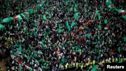 FILE - Palestinian Hamas supporters take part in a rally marking the 30th anniversary of Hamas' founding, in Gaza City, Dec. 14, 2017. 