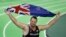 FILE - New Zealand's Tomas Walsh celebrates with a flag after he won the the men's shot put final during the World Indoor Athletics Championships, March 18, 2016, in Portland, Ore. 