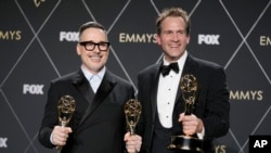 David Furnish, left, and Luke Lloyd Davies pose in the press room during the 75th Primetime Emmy Awards on Monday, Jan. 15, 2024, at the Peacock Theater in Los Angeles. (AP Photo/Ashley Landis)