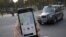 A photo illustration shows the Uber app on a mobile telephone in front of a London Taxi, in London, Britain, Nov. 10, 2017. 