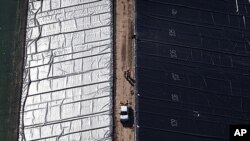 A facility for holding water pumped from underground during coal-seam gas mining is lined with black plastic before use on a property near Cecil Plains, 180 km (112 miles) west of Brisbane, October 31, 2011.