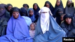 Remaining girls who were kidnapped from the northeast Nigerian town of Chibok are seen in an unknown location in Nigeria in this still image taken from an undated video obtained on January 15, 2018. Boko Haram Handout/Sahara Reporters via REUTERS