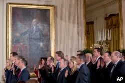 FILE - From left, President Donald Trump's advisors Kellyanne Conway, Jared Kushner, Steve Bannon, and Trump Chief of Staff Reince Priebus, and other members of White House senior staff are sworn in at the White House, in Washington, Jan. 22, 2017.