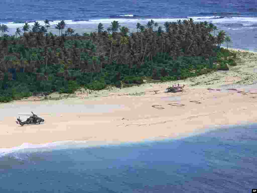 In this photo provided by the Australian Defence Force, an Australian Army helicopter lands on Pikelot Island in the Federated States of Micronesia, where three men were found, Aug. 2, 2020, safe and healthy after missing for three days.