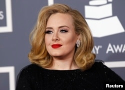 FILE - British singer Adele arrives at the 54th annual Grammy Awards in Los Angeles, California, Feb. 12, 2012.