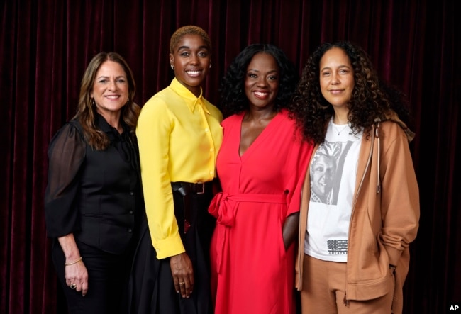 FILE - Cathy Schulman, one of the producers of "The Woman King," cast members Lashana Lynch and Viola Davis, and director Gina Prince-Bythewood pose together for a portrait at the Ritz-Carlton Hotel, during the Toronto International Film Festival, Thursday, Sept. 8, 2022, in Toronto. (AP Photo/Chris Pizzello)