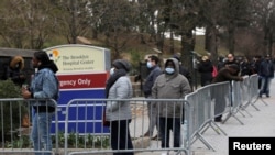 People line up to enter a tent erected to test for the coronavirus disease (COVID-19) at the Brooklyn Hospital Center in Brooklyn, New York City, March 19, 2020.