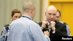 Anders Breivik, serving a sentence for the 2011 killing of 77 people, has his handcuffs removed inside the court room in Skien prison, Norway, March 16, 2016. He claims that conditions to which he is subjected in prison are a violation of his human rights.