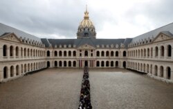 People queue to pay tribute to late French President Jacques Chirac during a popular national tribute at the Hotel des Invalides in Paris.