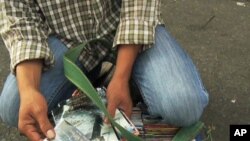 A vendor sells pirated DVDs in Vietnam