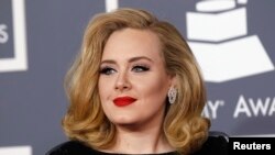 FILE - British singer Adele arrives at the 54th annual Grammy Awards in Los Angeles, Feb. 12, 2012. 