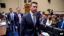 Acting Secretary of Homeland Security Kevin McAleenan, right, departs during a break in testimony before a House Committee on Oversight and Reform hearing on Capitol Hill in Washington, July 18, 2019. 