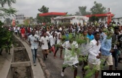 FILE - Congolese opposition supporters chant slogans during a march to press President Joseph Kabila to step down in the Democratic Republic of Congo's capital, Kinshasa, Sept. 19, 2016.