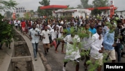 FILE - Congolese opposition supporters chant slogans during a march to press President Joseph Kabila to step down in the Democratic Republic of Congo's capital, Kinshasa, Sept. 19, 2016. 