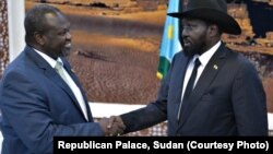 South Sudan rebel leader Riek Machar,left, shakes hands with Salva Kiir. Machar is the leader of the Sudan People’s Liberation Movement In Opposition. Kiir is leader of the Sudan People's Liberation Movement. 