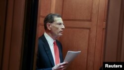 Senator John Barrasso (R-WY) talks to journalists in an elevator at the United States Capitol building in Washington