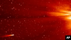 In frame grab taken from enhanced video made by NASA's STEREO-A spacecraft, comet ISON, left, approaches sun, Nov. 25, 2013.