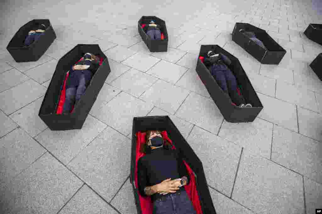 Women laying in coffins representing those killed in domestic violence during an event for upcoming International Women&#39;s Day in front of Tel Aviv&#39;s district court, Israel.