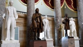 FILE - In this June 24, 2015 file photo, a statue of Jefferson Davis, second from left, president of the Confederate States from 1861 to 1865, is on display in Statuary Hall on Capitol Hill in Washington. (AP Photo/Susan Walsh, File)