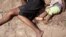 The body of a woman and her daughter lie on the ground following an overnight attack on Jon the village of Kibusu in the Tana river Delta region in Kenya, January 10, 2013.