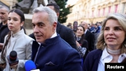 FILE - Calin Georgescu and his wife Cristela Georgescu arrive at the Central Electoral Bureau where Georgescu submitted his candidacy for the May presidential ballot re-run, in Bucharest, March 7, 2025. Inquam (Inquam Photos/Octav Ganea via Reuters) 