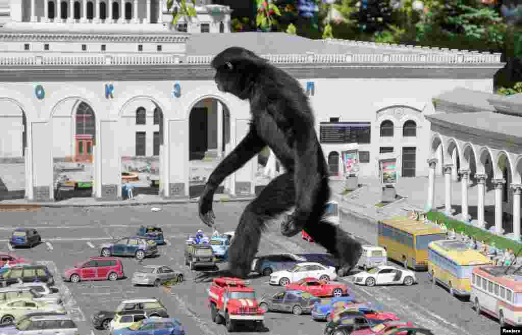 A gibbon walks amid models of vehicles at a zoo in the park of miniatures in Bakhchisaray, Crimea.