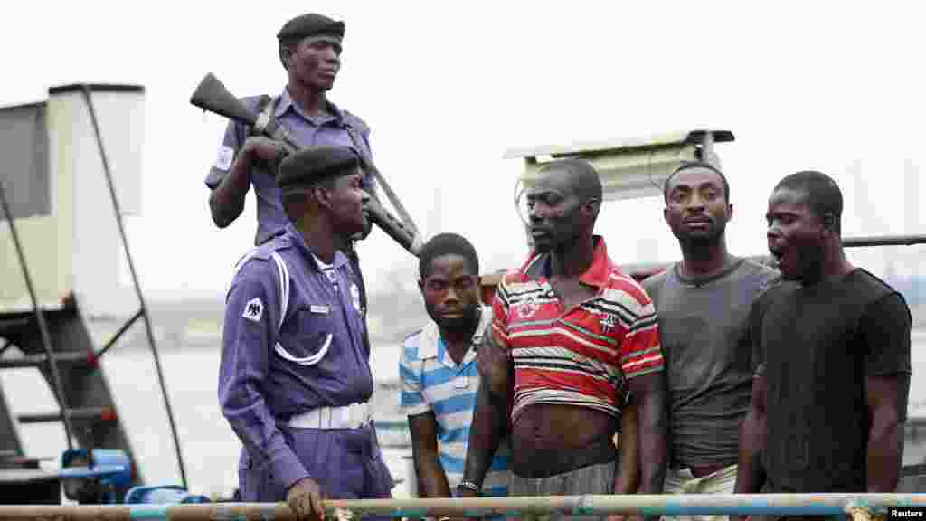 Suspected pirates are paraded aboard a naval ship after their arrest by the Nigerian Navy at a defence jetty in Lagos, August 20, 2013.