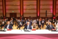 FILE - Abdullah Abdullah, center, chairman of Afghanistan's High Council for National Reconciliation, attends the opening session of the peace talks between the Afghan government and the Taliban in Doha, Qatar, Sept. 12, 2020.