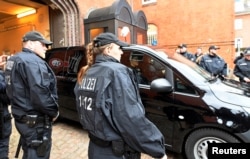 A vehicle, believed to carry detained former Catalan leader Carles Puigdemont, leaves the prison in Neumuenster, March 26, 2018.