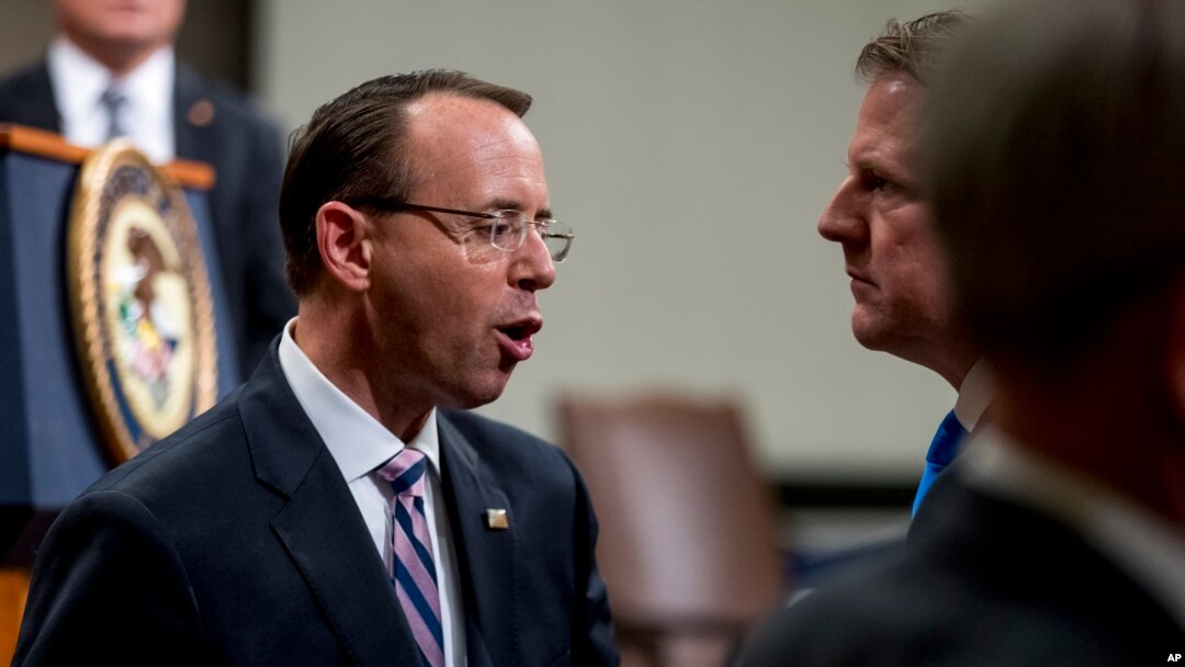 Deputy Attorney General Rod Rosenstein, left, speaks with former White House Counsel Don McGahn, right, following a farewell ceremony for Rosenstein in the Great Hall at the Department of Justice in Washington, Thursday, May 9, 2019.