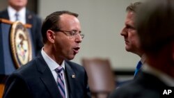 Deputy Attorney General Rod Rosenstein, left, speaks with former White House Counsel Don McGahn, right, following a farewell ceremony for Rosenstein in the Great Hall at the Department of Justice in Washington, Thursday, May 9, 2019.