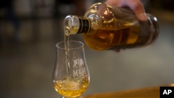 Whiskey is poured at the 'Milk and Honey' whiskey distillery in Tel Aviv, Israel, Aug. 10, 2017.