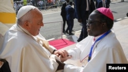 FILE: Pope Francis speaks with a clergyman as he meets with priests, deacons, consecrated people and seminarians at the Cathedral of Saint Therese during his apostolic journey, in Juba, South Sudan, on February 4, 2023.