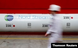FILE - The logo of the Nord Stream 2 gas pipeline project is seen on a pipe at the Chelyabinsk pipe rolling plant in Chelyabinsk, Russia, Feb. 26, 2020.