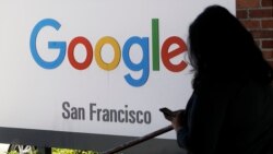 In this May 1, 2019, file photo, a person walks past a Google sign in San Francisco. (AP Photo/Jeff Chiu, File)