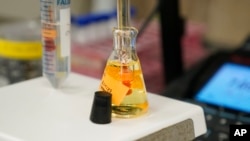 FILE - A water sample is measured as part of a PFAS drinking water treatment experiment, Feb. 14, 2023, at the U.S. Environmental Protection Agency in Cincinnati.