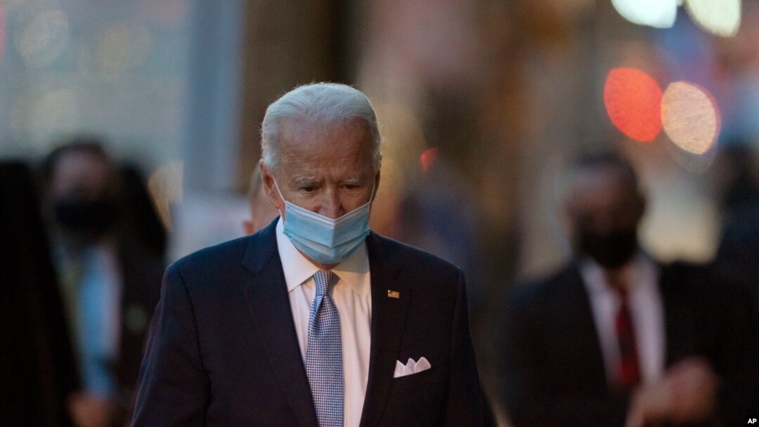 President-elect Joe Biden walks to speak to the media as he leaves The Queen theater, Nov. 24, 2020, in Wilmington, Del.