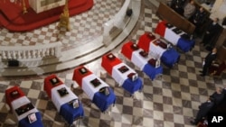 French President Nicolas Sarkozy, stood right of flag-draped coffins inside the Invalides church as tribute is paid by France to the seven French soldiers killed last week in Afghanistan during a national ceremony in Paris, July 19, 2011
