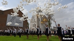 Children release white balloons outside the former school, which came under an attack by Islamist militants in 2004 and is currently a center of patriotic education and terrorism prevention, during a ceremony marking the 20th anniversary of the siege, Sept. 3, 2024.