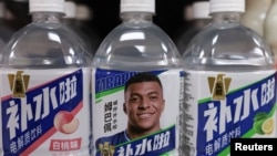 Bottled drinks by Eastroc Beverage with images of French soccer player Kylian Mbappe are displayed on a shelf at a store, in Beijing, China October 27, 2026.