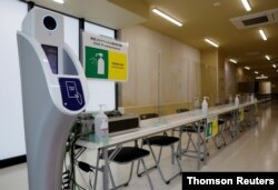A machine to check body temperature and hand sanitizers are placed at the doping control station of the Tokyo 2020 Olympic and Paralympic Village in Tokyo, Japan, June 20, 2021.