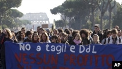 Students in Rome hold up a banner saying: 'No to cuts and proposed bill, no profit on our future' as they march past the Colosseum, 25 Nov 2010