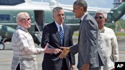 President Barack Obama, second from right, reaches to shake hands with Philippine Ambassador to the U.S. Jose Cuisia Jr., left, as Philippines Defense Secretary Voltaire Gazmin, right, and U.S. Ambassador to the Philippines Philip Goldberg, second from left, watch, at Ninoy Aquino International Airport in Manila, Philippines, Tuesday, Nov. 17, 2015. (AP Photo/Susan Walsh)