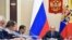 FILE - Russian President Vladimir Putin, right, presides over a cabinet meeting at the Novo-Ogaryovo residence outside Moscow, Russia.