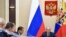 file - Russian President Vladimir Putin, right, presides over a cabinet meeting at the Novo-Ogaryovo residence outside Moscow, Russia.
