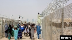 People arriving from Afghanistan make their way at the Friendship Gate crossing point at the Pakistan-Afghanistan border town of Chaman, Pakistan, Aug. 16, 2021. 